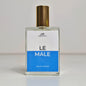 A glass perfume bottle with gold cap and blue and white label saying 'Le Male'