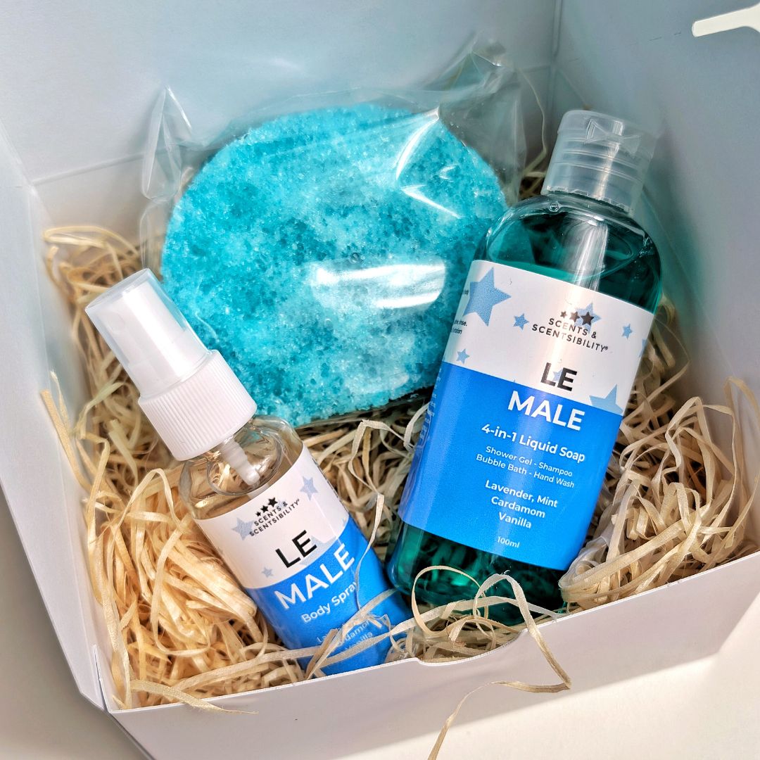 A white box with wood wool and three Le Male Bath & Body Products