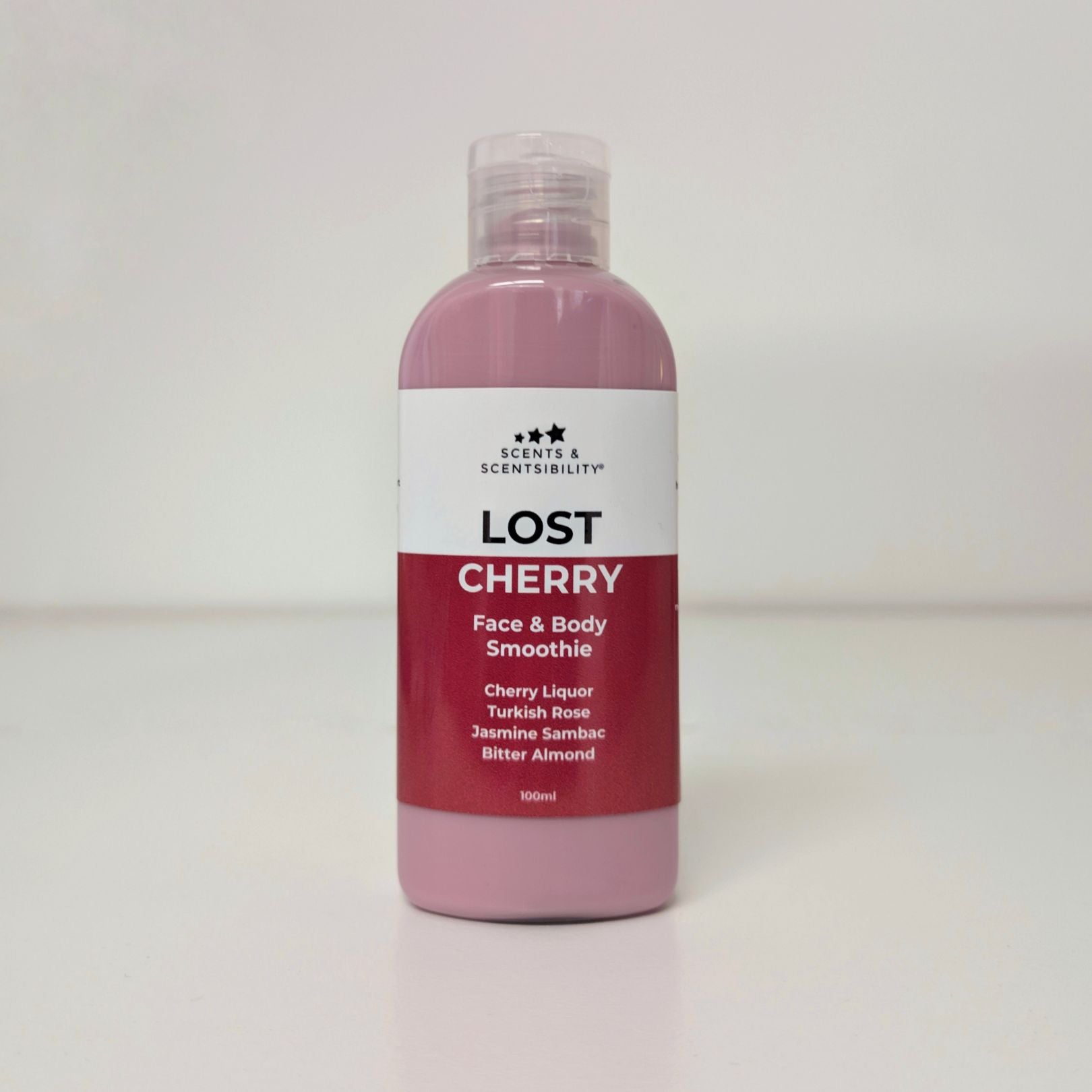 Bottle of 'Lost Cherry' face and body smoothie with a white label on a light grey background