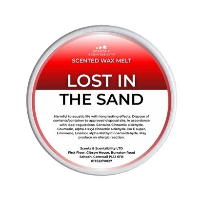 Scented wax melt container labeled 'Lost in the Sand' with Scents & Sensibility branding on a green background.