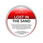 Scented wax melt container labeled 'Lost in the Sand' with Scents & Sensibility branding on a green background.