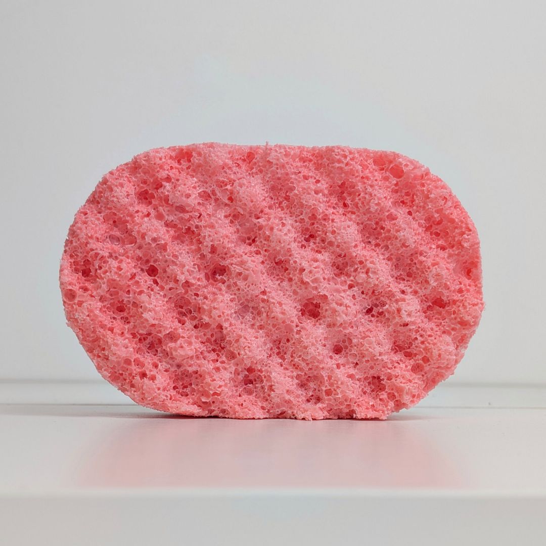 Pink sponge on a light gray background