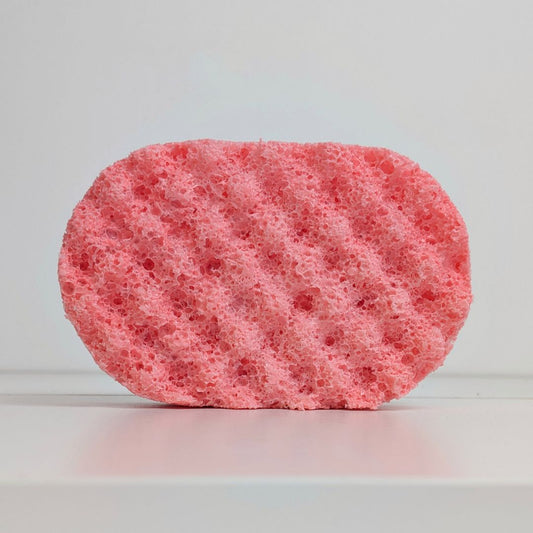 Pink sponge on a light gray background