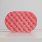 Pink sponge on a light gray background