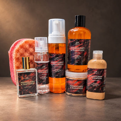 Scents & Scentsibility Mahogany & Teakwood bath, body and fragrance collection, featuring eau de parfum, body spray, foaming hand soap, liquid soap, whipped soap and face and body lotion, styled against a warm, dark masculine background.