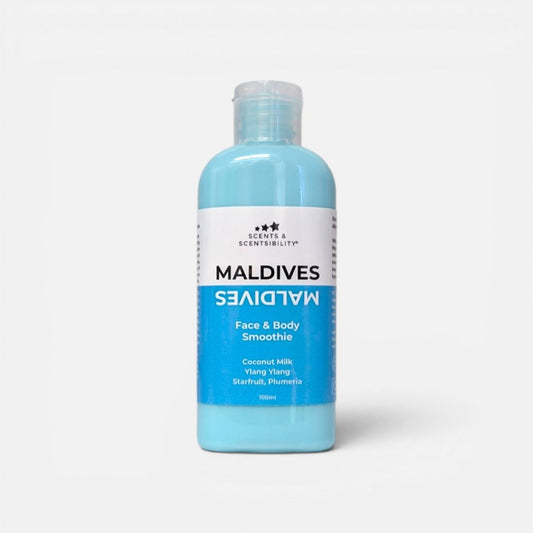 A bottle of Maldives Face & Body Smoothie Lotion in a light blue color, featuring a white and blue label, on a light gray background.