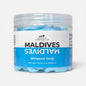 A clear plastic jar of Scents & Scentsibility Maldives Whipped Soap, showing light blue whipped soap inside, with a white and blue label on a light gray background.