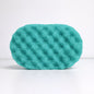 Green textured soap sponge on a white background