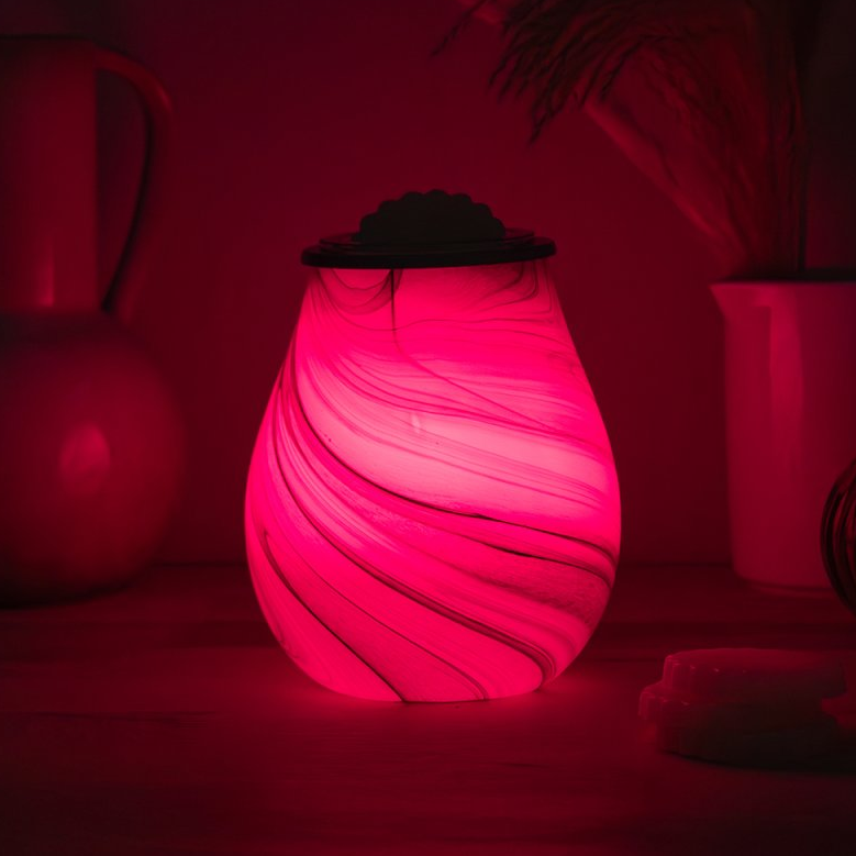 Red Wax Melt Warmer in a dark setting with blurred background