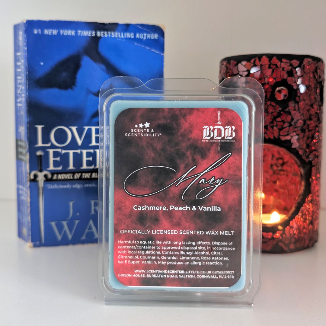 Scented wax melt packaging with a book and candle in the background