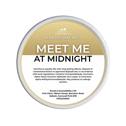 Scented wax melt container labeled 'Meet Me at Midnight' on a green background