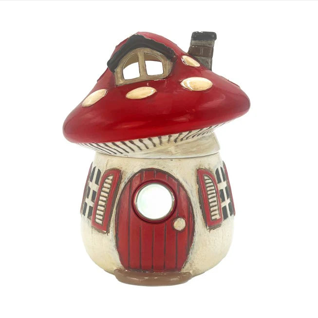 Decorative mushroom-shaped wax melt warmer with a red cap and door on a white background