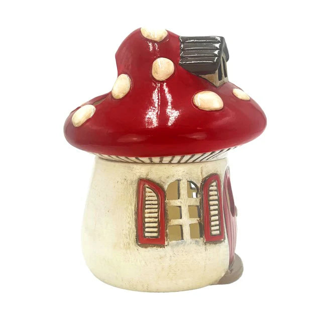 Mushroom-shaped wax melt warmer with red cap and beige stem on a white background