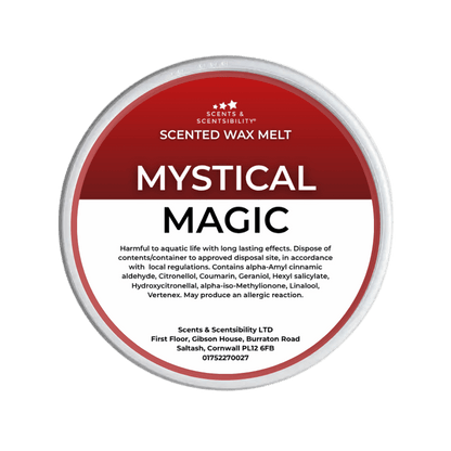 A Scents & Scentsibility 'Mystical Magic' scented wax melt, featuring a red and white label on a solid dark green background.
