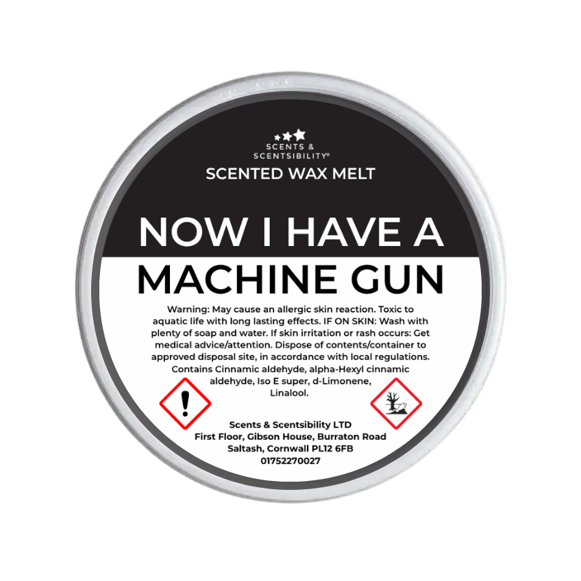 Scented wax melt container labeled 'Now I Have a Machine Gun' with warning text on a green background.