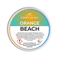A pot wax melt labeled 'Orange Beach' with a description of the scent blend, including mandarin orange, sea salt, and ozone.