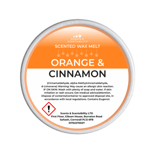 Scented wax melt container labeled 'Orange & Cinnamon' on a green background