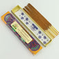 A box of Palo Santo incense sticks with their decorative packaging, shown on a clean white background. The incense sticks are brown, and the packaging features a colorful mandala pattern with a cream label.