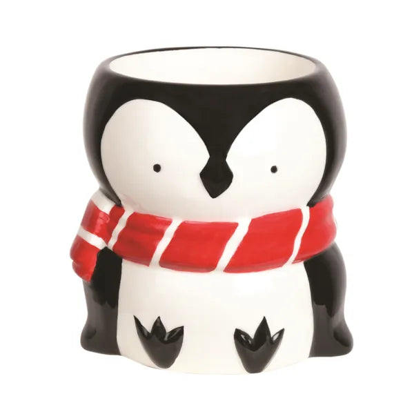 Penguin-shaped wax melt burner with a red scarf on a white background