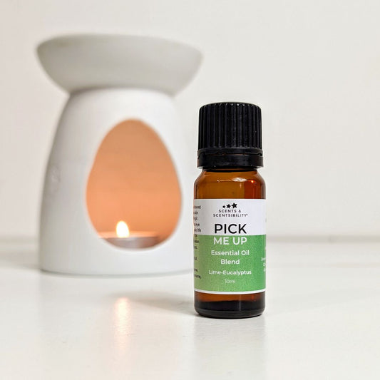 Bottle of 'Pick Me Up' essential oil blend with an oil burner in the background