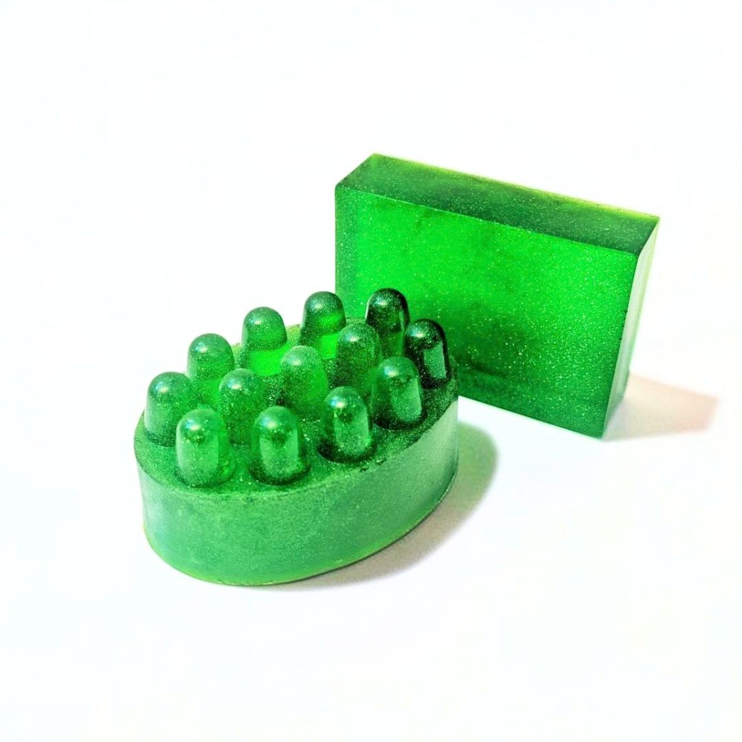 Green oval massage soap bar with raised textured bumps on a white background.