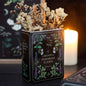 Decorative container with dried flowers labeled 'Library of Poisonous Plants' on a dark background.