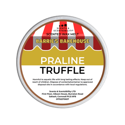 Scented wax melt container labeled 'Praline Truffle' from Barrie's Bakehouse on a green background