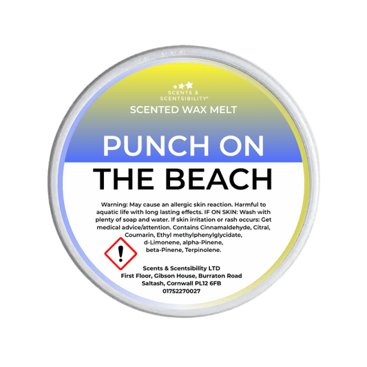 Scented wax melt container labeled 'Punch on the Beach' with warning text on a green background