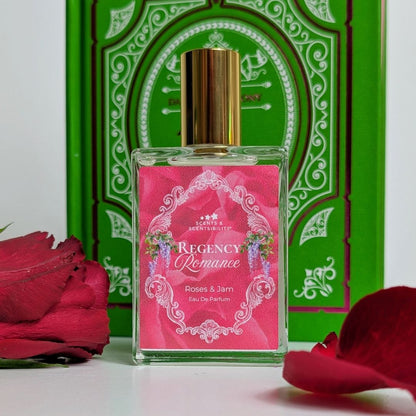 Perfume bottle labeled 'Regency Romance' with red rose petals and a green decorative box in the background.