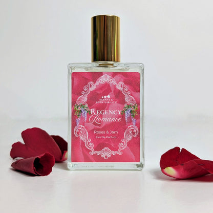 Perfume bottle labeled 'Regency Romance' with red rose petals on a light background