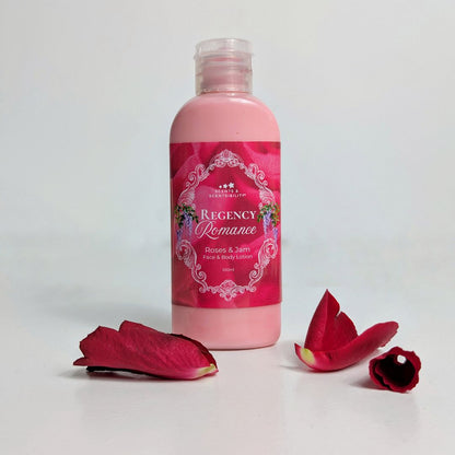 Pink bottle of 'Regency Romance' lotion with red flower petals on a light gray background