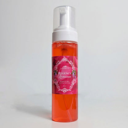 Red spray bottle with a pink label on a white background