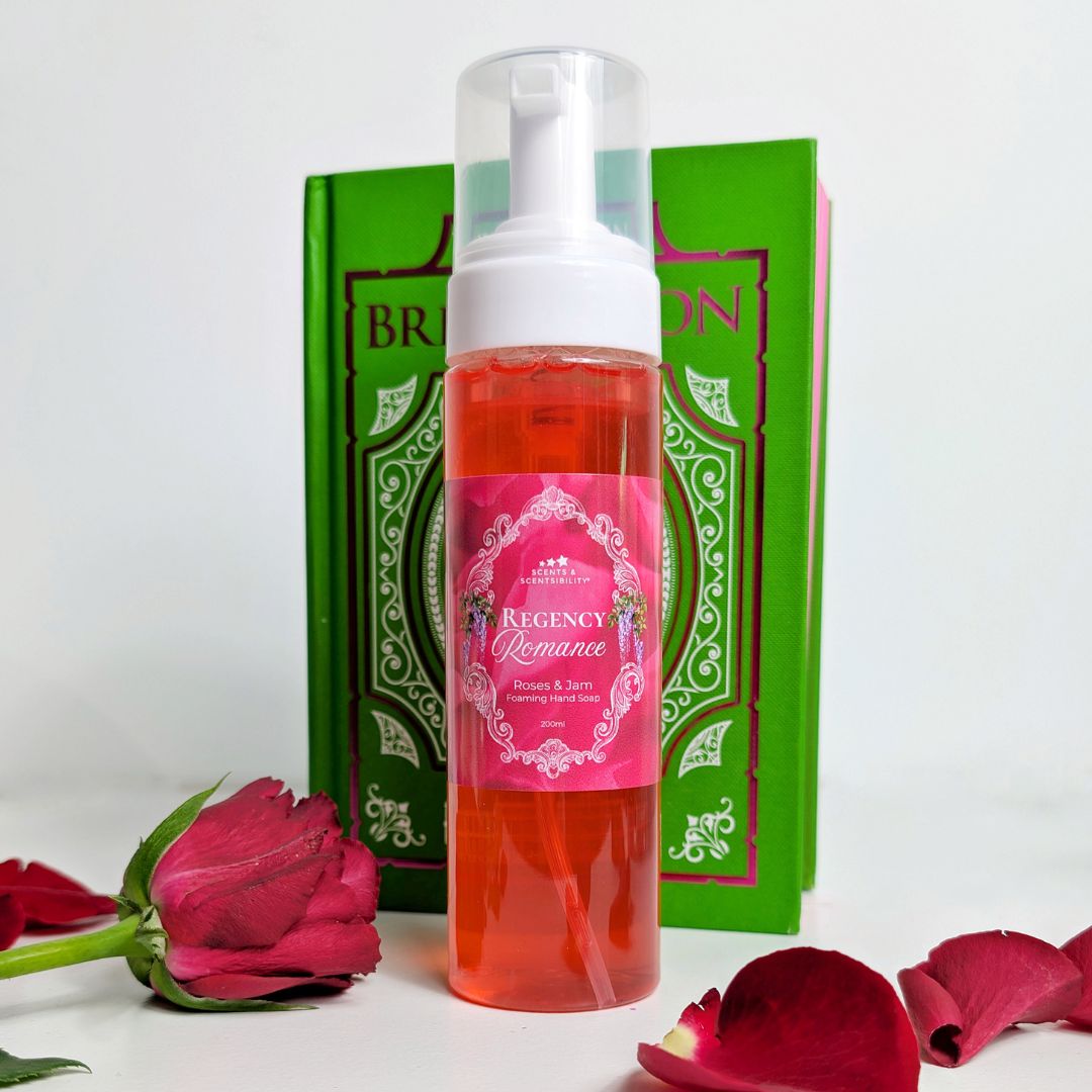 Foam bottle with pink liquid and decorative label on a white background with red roses and green packaging.