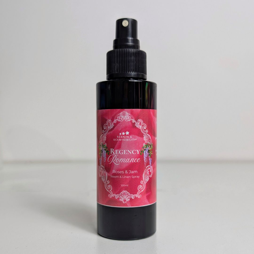 Black spray bottle with a pink label on a white background