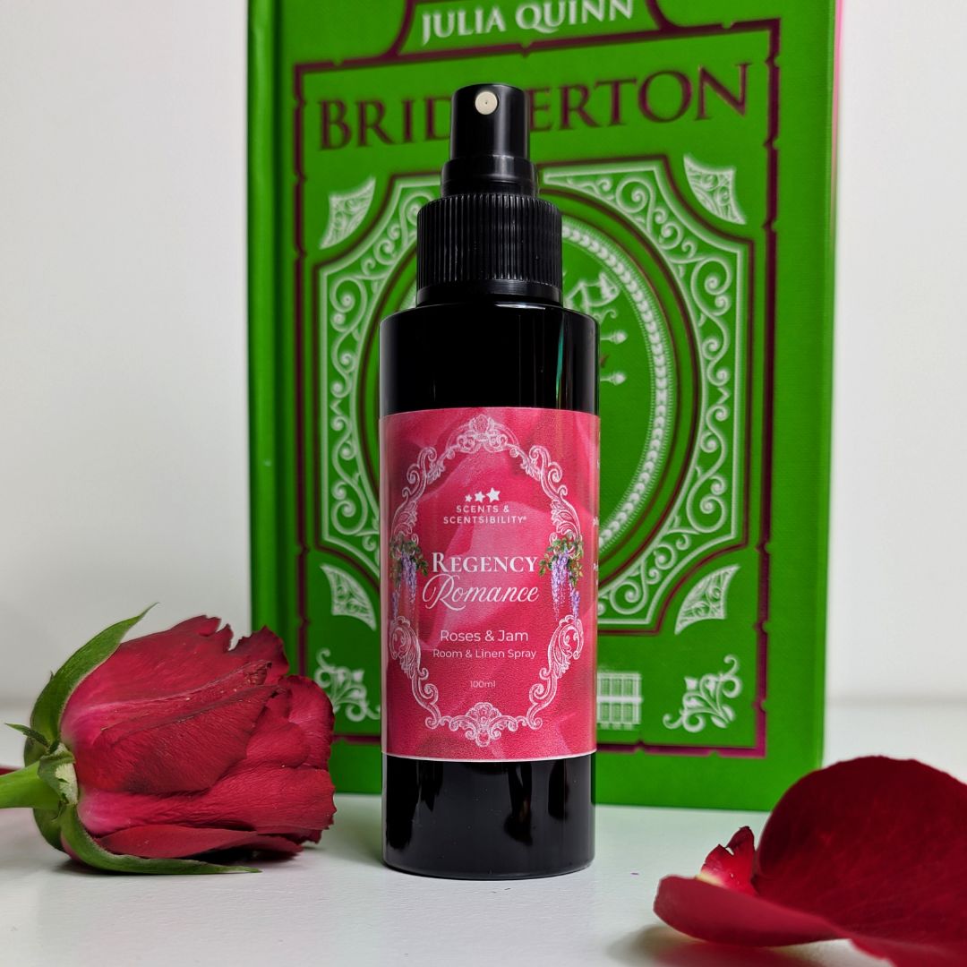 Bottle of 'Regency Romance' room spray with a red rose and book in the background