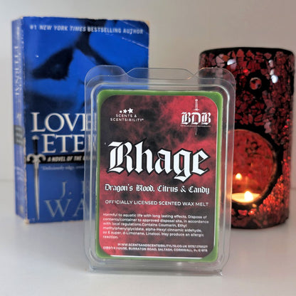 Scented wax melt package labeled 'Rhage' with a book and candle in the background.