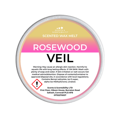 Scented wax melt container labeled 'Rosewood Veil' on a green background