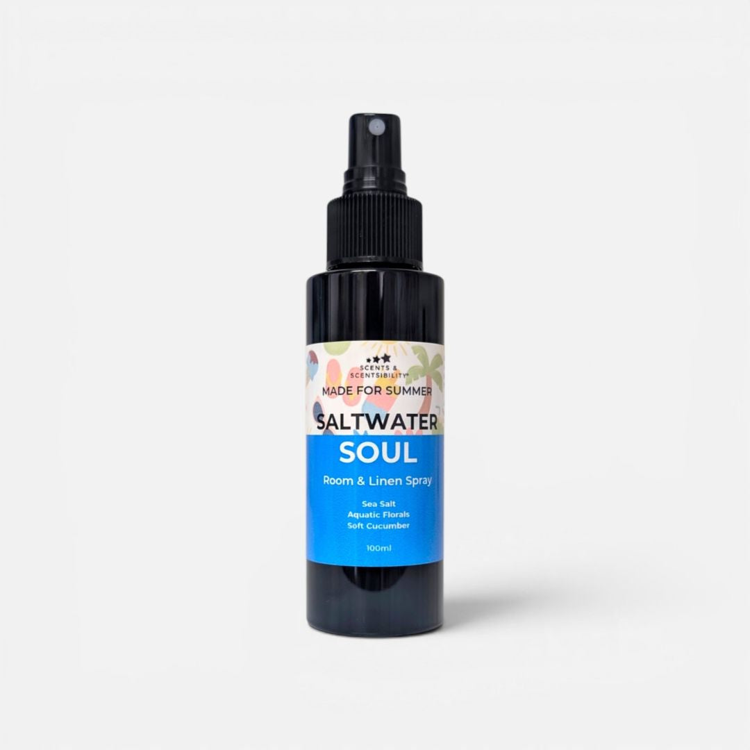 A black plastic spray bottle of 'Saltwater Soul' room and linen spray by 'Made For Summer', featuring a blue and white label, set against a plain light gray background.