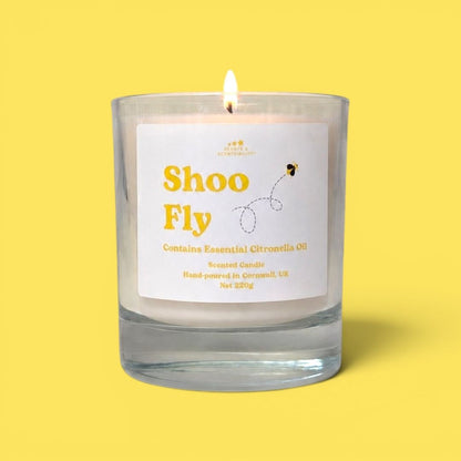Candle labeled 'Shoo Fly' on a yellow background