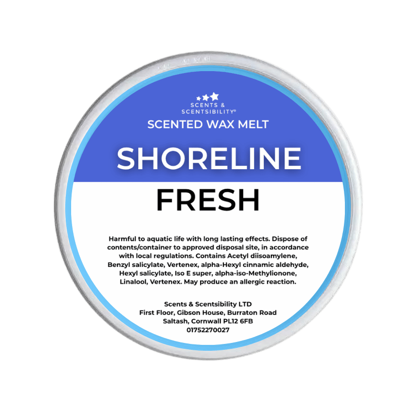 A Scents & Scentsibility 'Shoreline Fresh' scented wax melt, featuring a blue and white label on a solid dark green background.