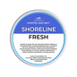 A Scents & Scentsibility 'Shoreline Fresh' scented wax melt, featuring a blue and white label on a solid dark green background.
