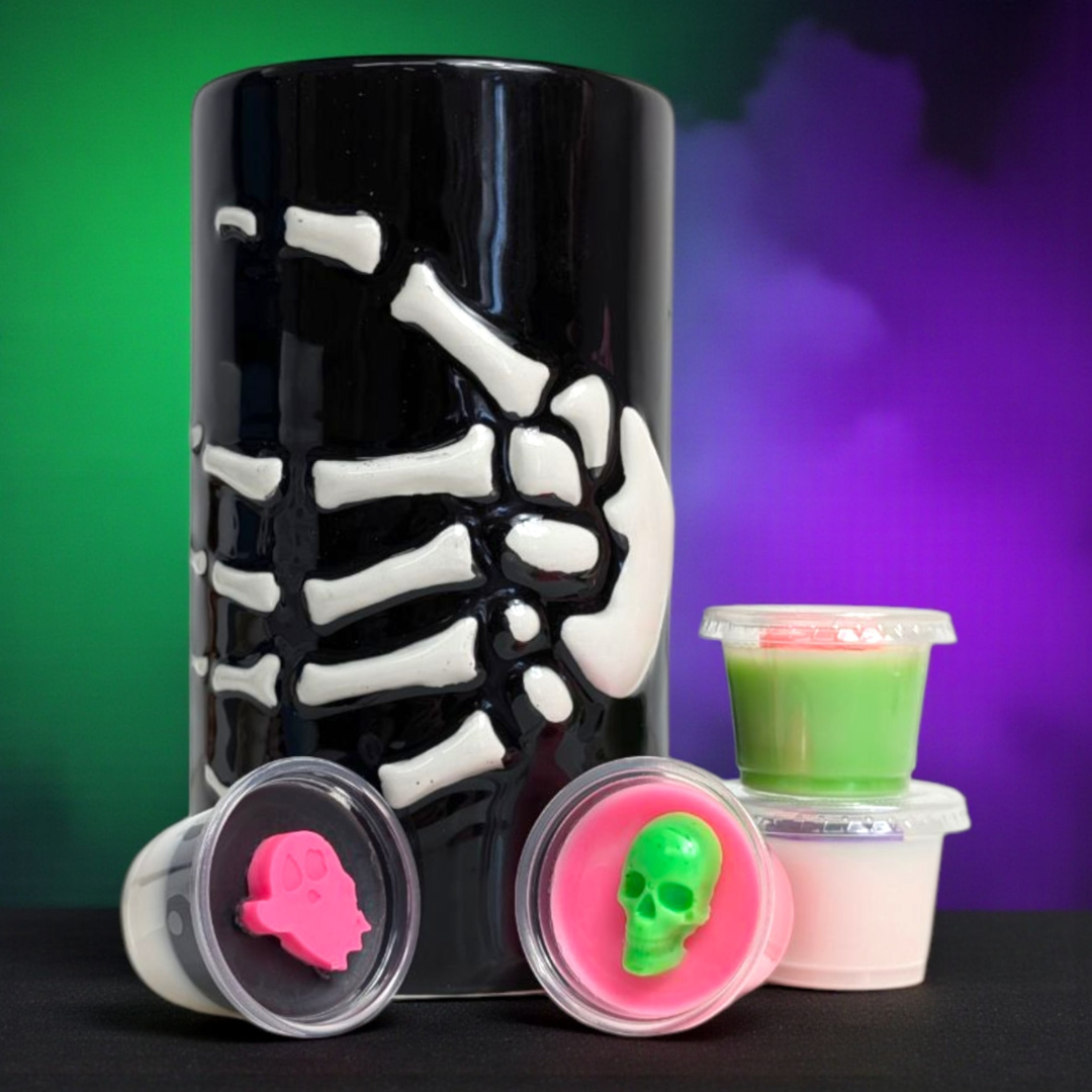 Skeleton Wax Melt Burner with Colourful Wax Melts on a spooky background