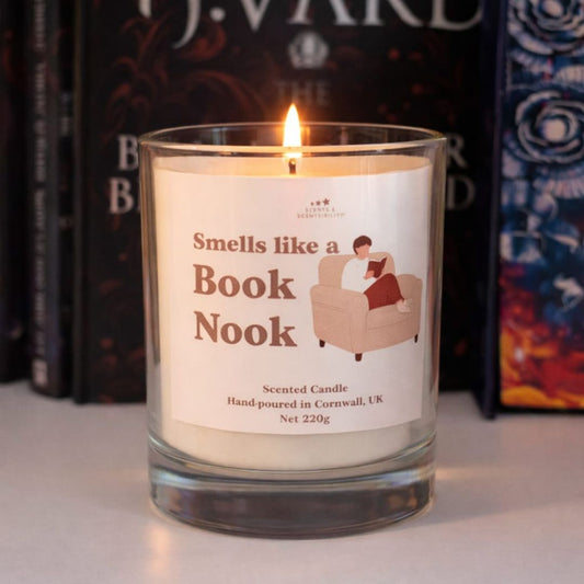 Scented candle labeled 'Smells like a Book Nook' with books in the background