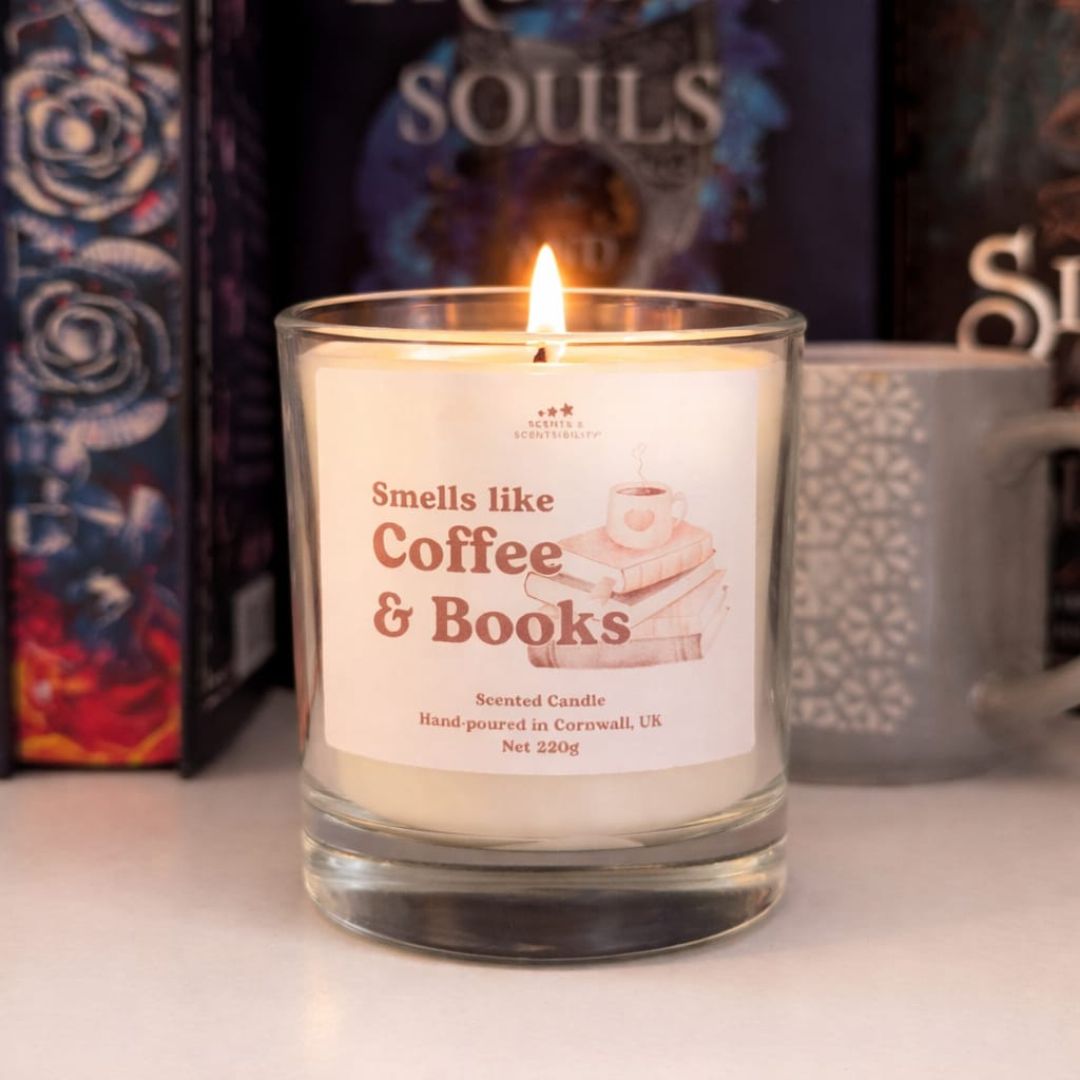 Candle labeled 'Smells like Coffee & Books' with a book and mug in the background