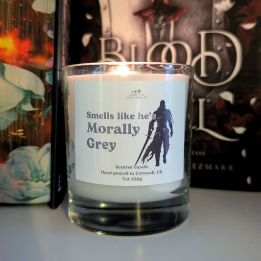 Candle with a label in front of a book titled 'Blood and Steel' by Helen Scheurer