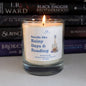 Candle labeled 'Smells like Rainy Days & Reading' in front of stacked books