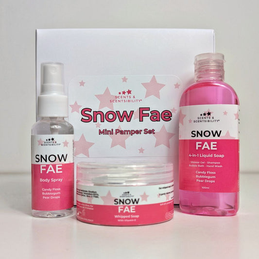 A White Gift box with mini bath & body products with pink and white labels saying 'Snow Fae'
