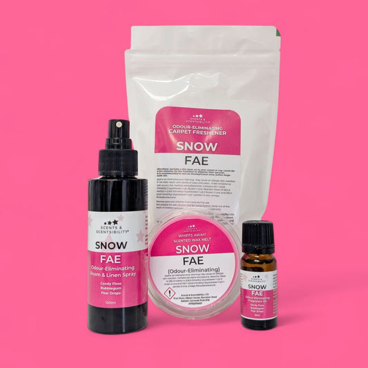 Snow Fae product set including a spray bottle, pouch, and essential oil bottle on a pink background