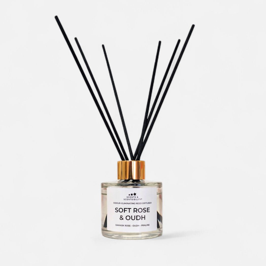 Diffuser with black sticks labeled 'Soft Rose & Oudh' on a white background