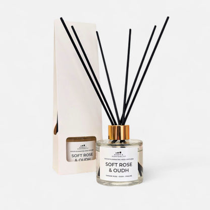 Diffuser with reeds and packaging labeled 'Soft Rose & Oudh' on a white background